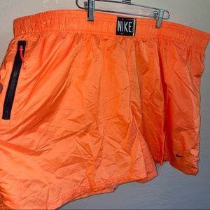 NIKE. neon orange athletic shorts.